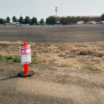 A close-up of the cone and "no parking" sign.