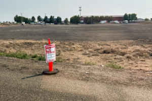 A close-up of the cone and "no parking" sign.