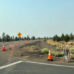 Cones and "no parking" signs placed along Airport Way.